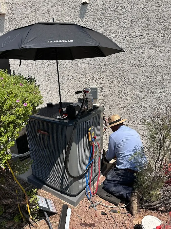 HVAC technician performing outdoor AC maintenance in Durham
